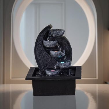 Джерело води Zen'Light Zimmerbrunnen V2 з 4 рівнями, імітація натурального каменю та кольоровим LED-підсвічуванням. Сучасна декор для столу, ідеально для медитації та релаксації. Висота 26 см. Унікальний дизайн.